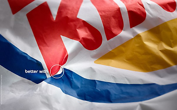 Folded fast-food packaging reveals a Pepsi globe.